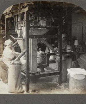 Filling and sewing bags of granulated sugar, New York. [1862?-1915?]