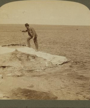 Fisherman at lake turning to cook in a boiling spring the trout just caught, Yellowstone Park, U.S.A. 1901, 1903, 1904