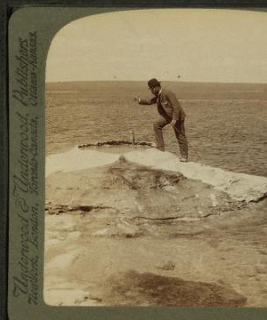 Fisherman at lake turning to cook in a boiling spring the trout just caught, Yellowstone Park, U.S.A. 1901, 1903, 1904