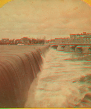 [Water pouring over a dam.] 1869?-1910?