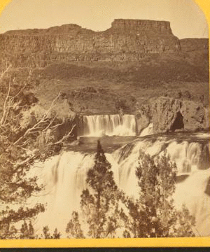 Shoshone Falls, Snake River, Idaho, looking through the timber, and showing the main fall, and upper or "Lace Falls." 1874