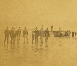 Landing of the French Atlantic telegraph cable on Duxbury Beach, with the officers of the steamers and barges that landed the cable on shore, in the foreground. 1860?-1880?