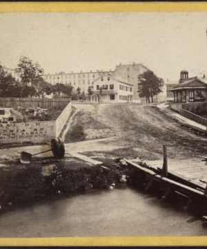 View from the Goat Island Bridge, looking towards the International Hotel. [1860?-1875?]