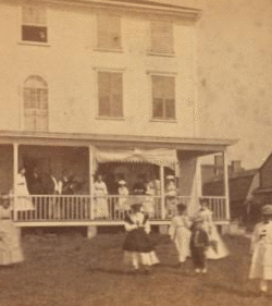 [Group playing croquet in front of house or boarding house.] 1859?-1885?
