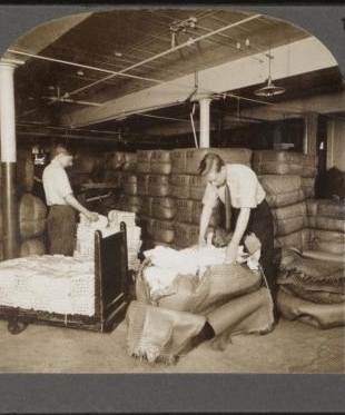 Opening bales of raw silk as it arrives from China, Japan and Italy. Silk industry (reeled silk), South Manchester, Conn., U.S.A. c1914 1914