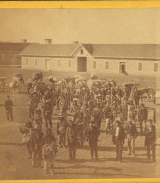 Taken at Fort Wingate, Dec. 11, 1871 [a group of native Americans and Burros in front of a building.] 1870?-1908