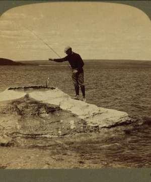 Fisherman at lake turning to cook in a boiling spring the trout just caught, Yellowstone Park, U.S.A. 1901, 1903, 1904