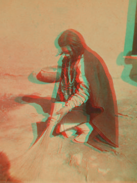 Pueblo woman sweeping her floor. 1870?-1908