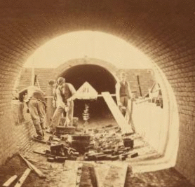 Sudbury River Conduit, B.W.W., div. 4, sec. 15, Nov. 13, 1876. View from inside of conduit; brickmasons at work in the east terminal chamber of bridge. 1876?-1878?