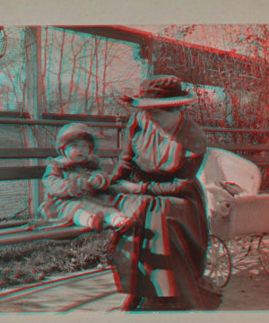 [Mother and child sitting in a park.] 1915-1919 October 1917