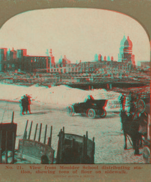 View from Moulder School distributing station, showing tons of flour on sidewalk. 1906