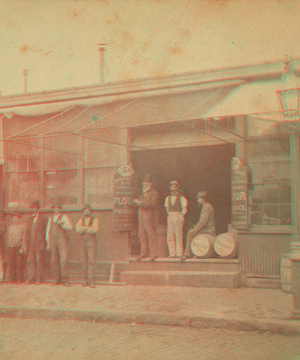 Unidentified grocery with men in front