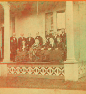 [Group of elderly women and men on a porch, in Whitinsville.] 1865?-1885?