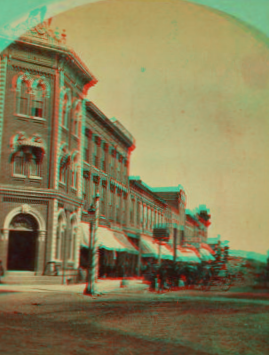 View of a commercial block with buildings and stores. 1868?-1885? ca. 1880