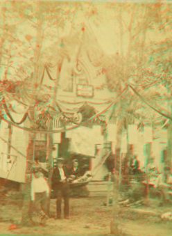 [Cottage and yard decorated with bunting.] 1865?-1880?