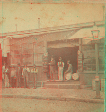 Unidentified grocery with men in front