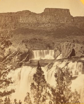 Shoshone Falls, Snake River, Idaho, looking through the timber, and showing the main fall, and upper or "Lace Falls." 1874