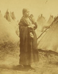 [Portrait of a Sioux (Dakota) woman named Wenona among a group of teepees.] 1862?-1875?