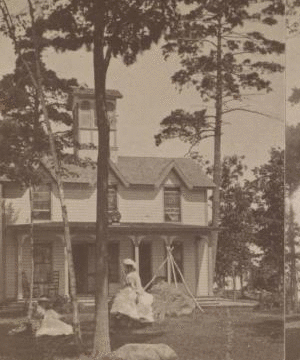 [Two women in front of small residential building.] 1870?-1890?