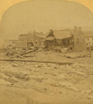 This view is looking toward the corners of Main and Clinton Streets, and shows the remains of the only buildings left standing on the one side of Clinton Street; also where stood the ill-fated Hulbert House where so many commercial men lost their lives. 1889