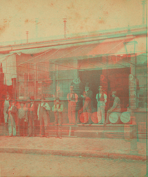 Unidentified grocery with men in front