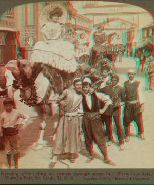 Dancing girls riding on camels through street in 'Mysterious Asia'. 1903-1905 1904