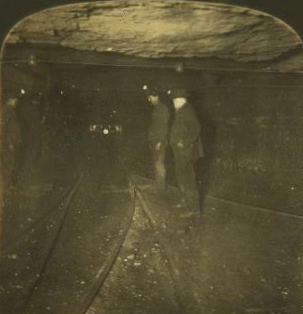 Group of miners in the main tunnel (1 1/2 miles long) of a huge coal mine, Pittsburg, Pa., U.S.A. 1868?-1915?