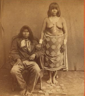 [Portrait of Indian man and woman, with playing cards.] 1865?-1885?