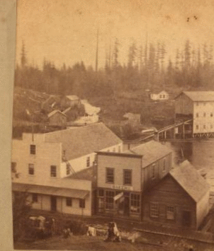 The creek on the left is Whatcom Creek, outlet for Lake Whatcom, 3 1/2 miles away and 330 Ft. above Whatcom; left hand building Terminal Hotel, my stopping place.... 187- 1870?-1920?