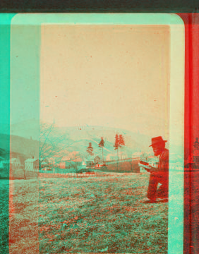 [Man with a book on hill overlooking farms at Greylock Hall.] 1865?-1885?