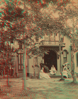 Four women and three girls seated by the entrance of their cottage on Martha's Vineyard