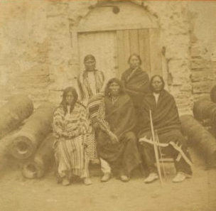 Group of the 3 most celebrated Indian Chiefs and 2 women prisoners, confined in the Old Spanish Fort. 1868?-1890? [1875-1878]