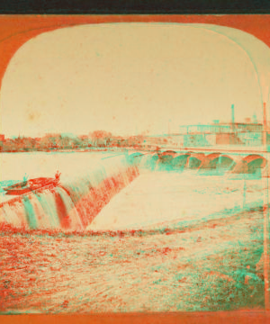 [Water pouring over a dam, men in boat peering over spillway.] 1869?-1910?