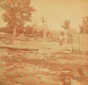 View of a log raft in the foreground with a building far behind, Dubuque, Iowa. 1865?-1875?