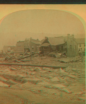 This view is looking toward the corners of Main and Clinton Streets, and shows the remains of the only buildings left standing on the one side of Clinton Street; also where stood the ill-fated Hulbert House where so many commercial men lost their lives. 1889