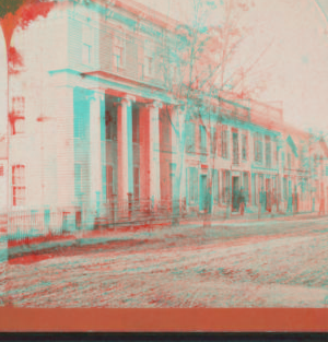 [View of a building with four men in front.] [1866?-1900?]