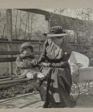 [Mother and child sitting in a park.] 1915-1919 October 1917