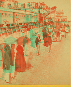 [People on the beach in front of the Plank Walk, some with umbrellas.] 1868?-1880?