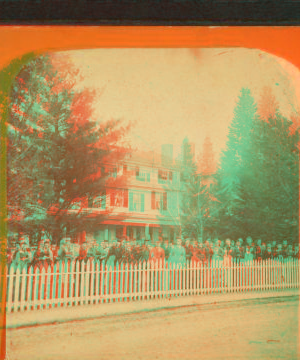 [View of a home with a large group of women in front.] 1863?-1880?