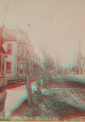 Congress Park, Bradford, Pa. [View down a street lined with row houses, oil derrick at the end of the street.] [1860?-1910?]