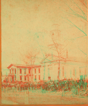 [Large group of people in front of a building.] May,1874