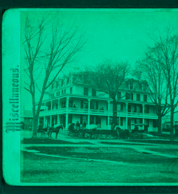 [View of large house with people and wagons in front.] 1865?-1905?