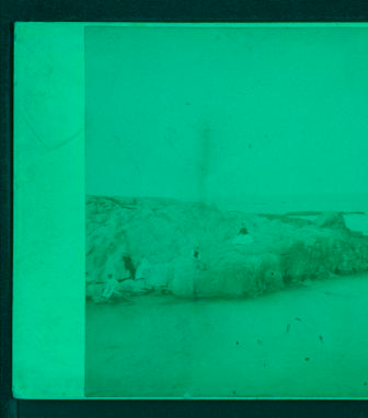 [View of people sitting on top of rocks in the beach.] 1860?-1885?