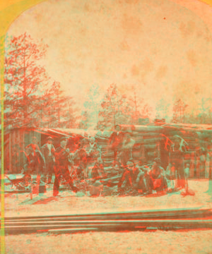 [Group of men in front of a log cabin.] 1870?-1900?