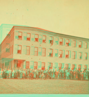 [C.T. Sampson's shoe factory with employees out front.] 1865?-1885?