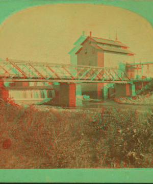 [View of a bridge and a building (possibly a mill) near the falls of a small river.] 1869?-1910?