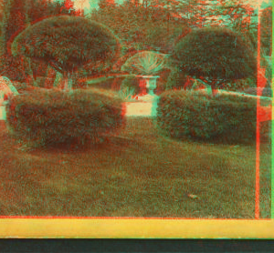 [View of a garden with topiary work and century plants in urns.] 1872