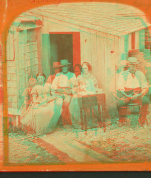 [Portrait of four people in front of a house.] 1868?-1885?