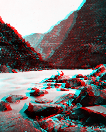 Clem Powell reading while sitting on a boulder in Cataract Canyon, Colorado River. Arizona.n.d.