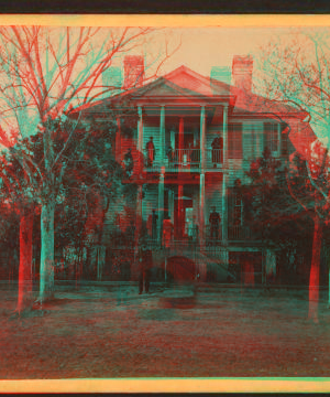 [View of a large house with civil and military personnel on porches.] 1865?-1905?